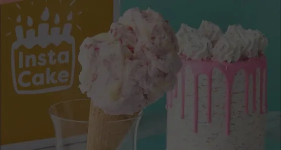An ice cream cone and a pink drip cake from InstaCake