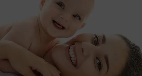 A mother holding her smiling baby, from Alana Healthcare