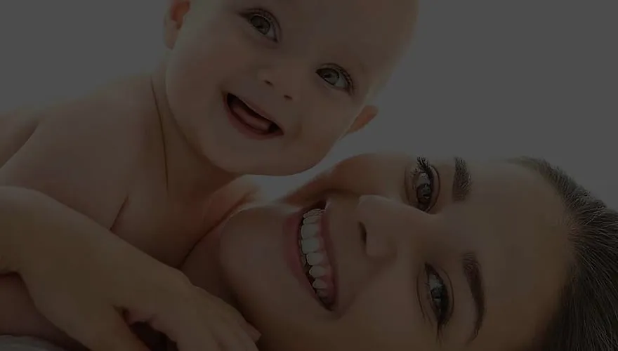 A mother holding her smiling baby, from Alana Healthcare