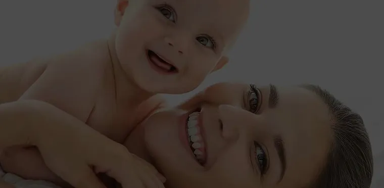 A mother holding her smiling baby, from Alana Healthcare