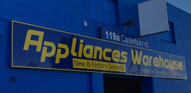 The blue Appliances Warehouse shopfront and street sign