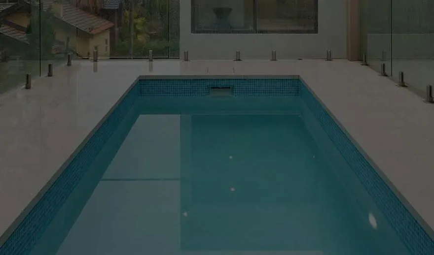 An indoor swimming pool with glass fencing, built by Mr Pools