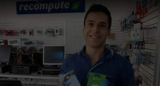 A technician behind the counter of the Recompute computer store