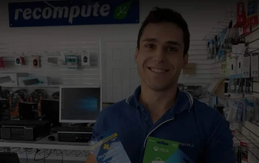 A technician behind the counter of the Recompute computer store