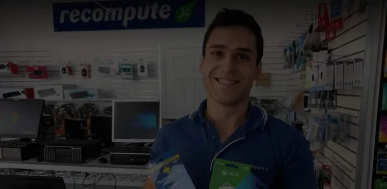 A technician behind the counter of the Recompute computer store