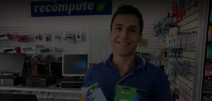 A technician behind the counter of the Recompute computer store