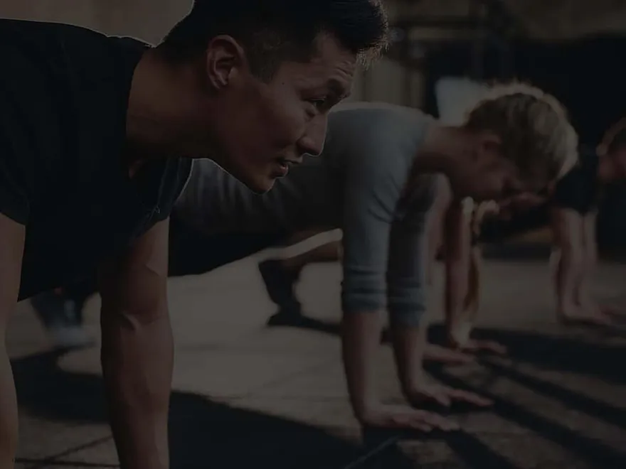A group push-up session in the gym, from Fitness Muscle Meals