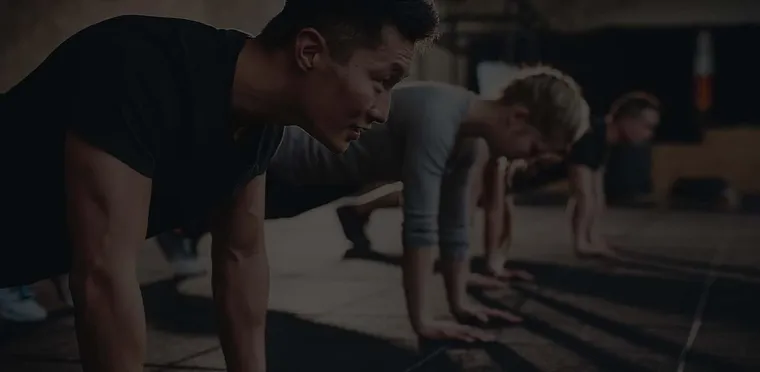 A group push-up session in the gym, from Fitness Muscle Meals