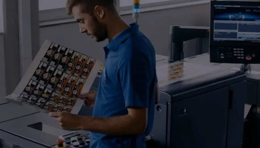 A Konica Minolta technician checking a printed colour sample