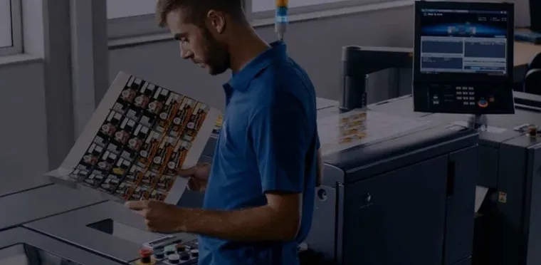 A Konica Minolta technician checking a printed colour sample