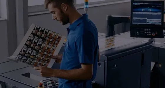 A Konica Minolta technician checking a printed colour sample