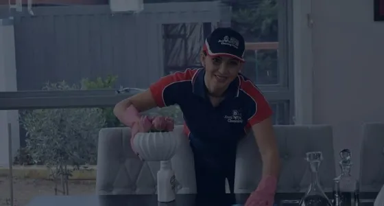 A Jim's Cleaning Melbourne cleaner working in a living room
