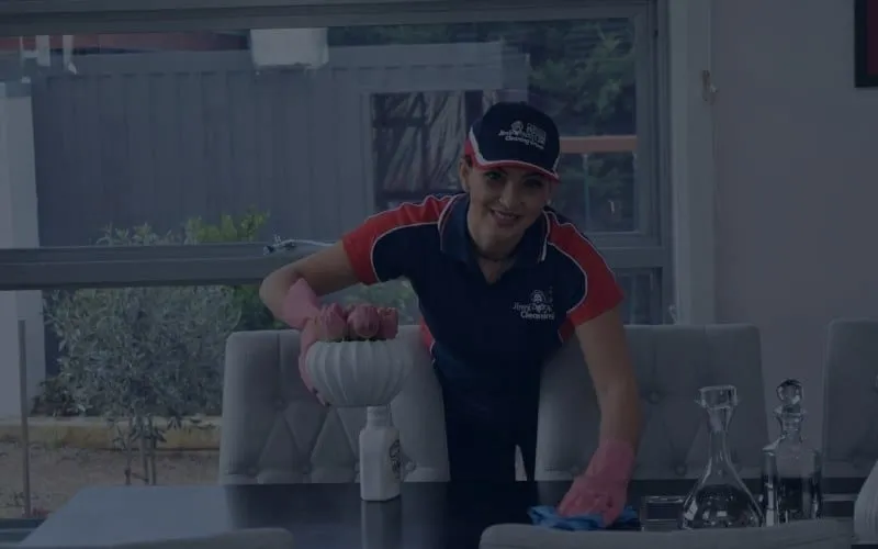 A Jim's Cleaning Melbourne cleaner working in a living room